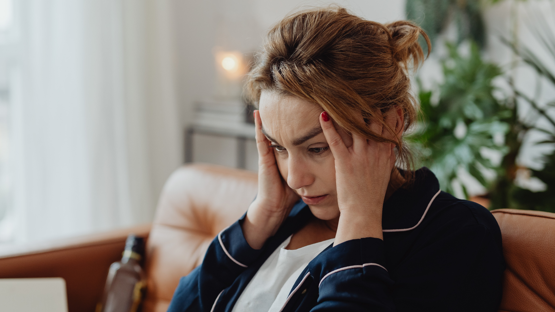 A woman holding her head. 