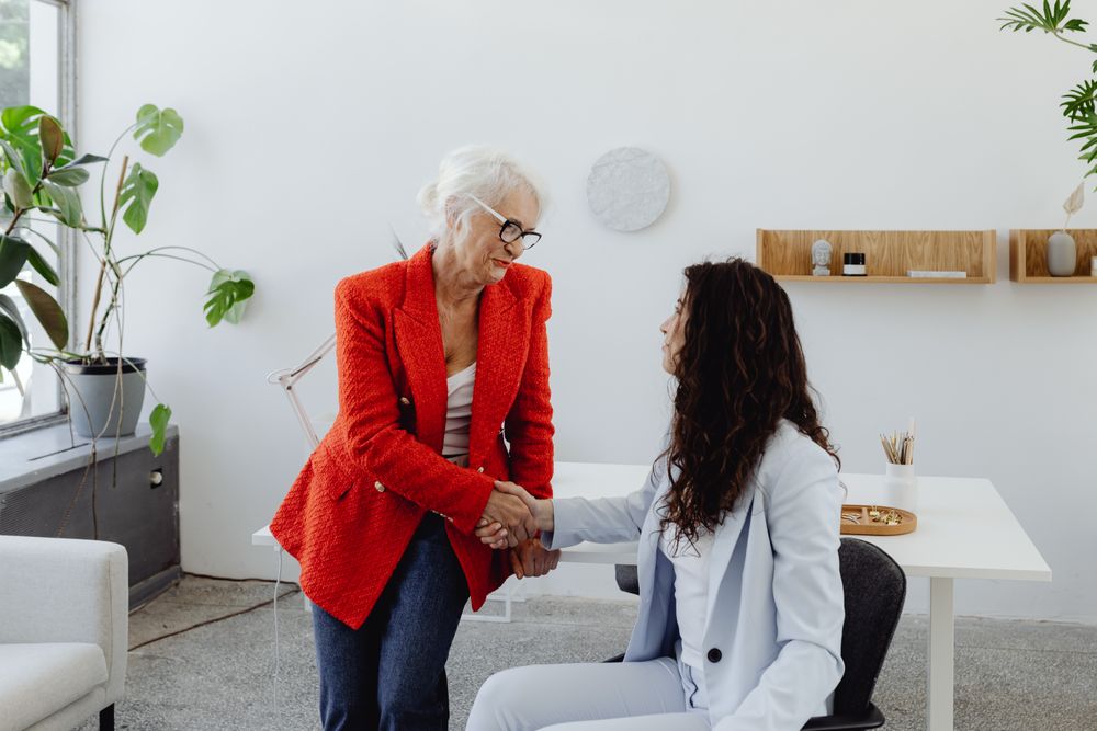A woman shaking hands with another woman