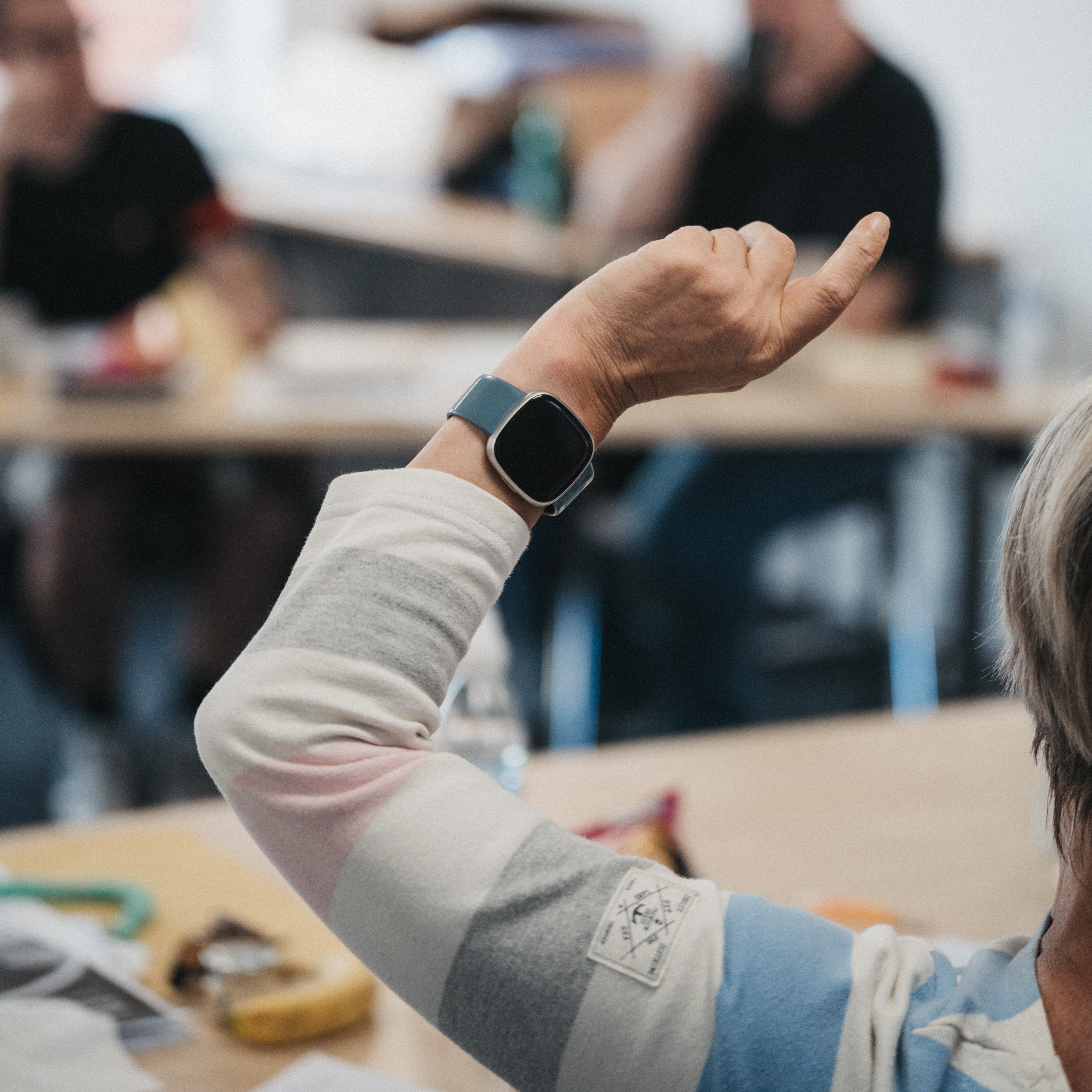 A woman raising her hand up