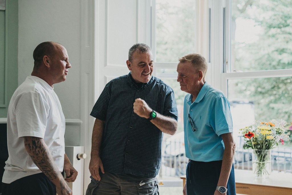 A group of men standing in a room