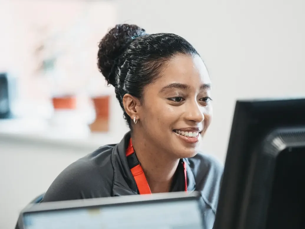 A woman looking at a computer screen