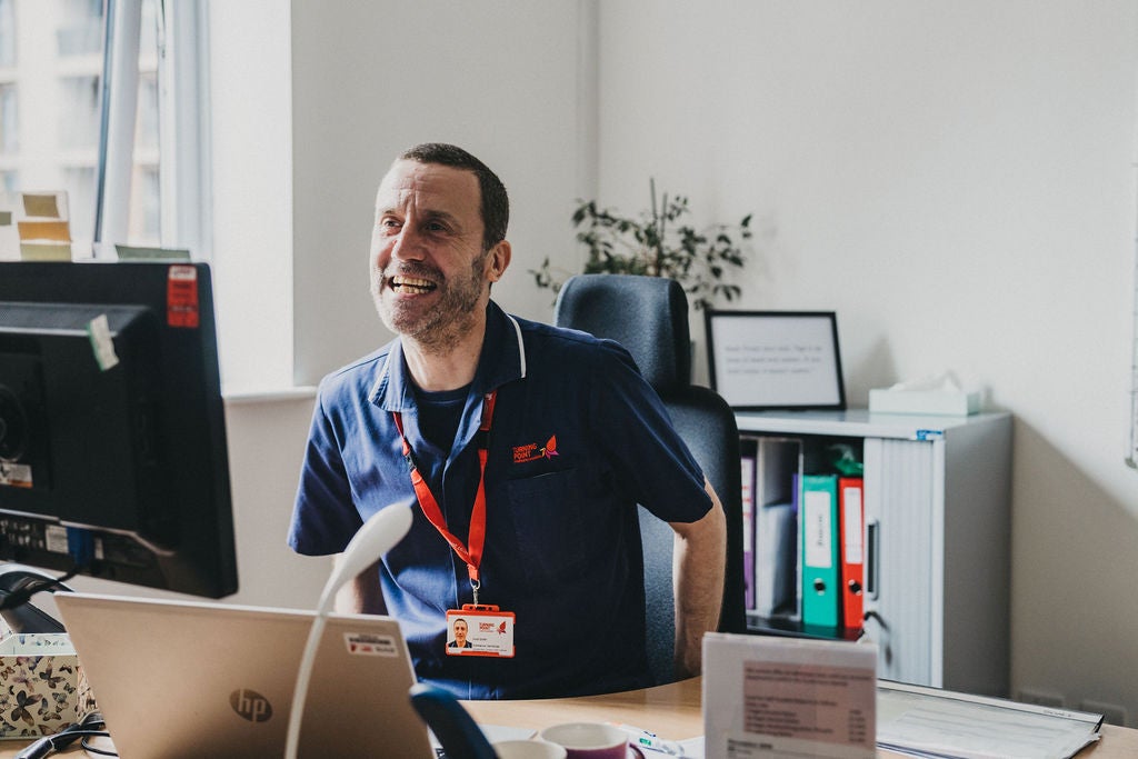 A man sitting at a desk with a computer