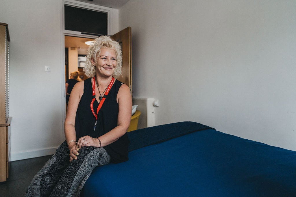 A woman sitting on a bed