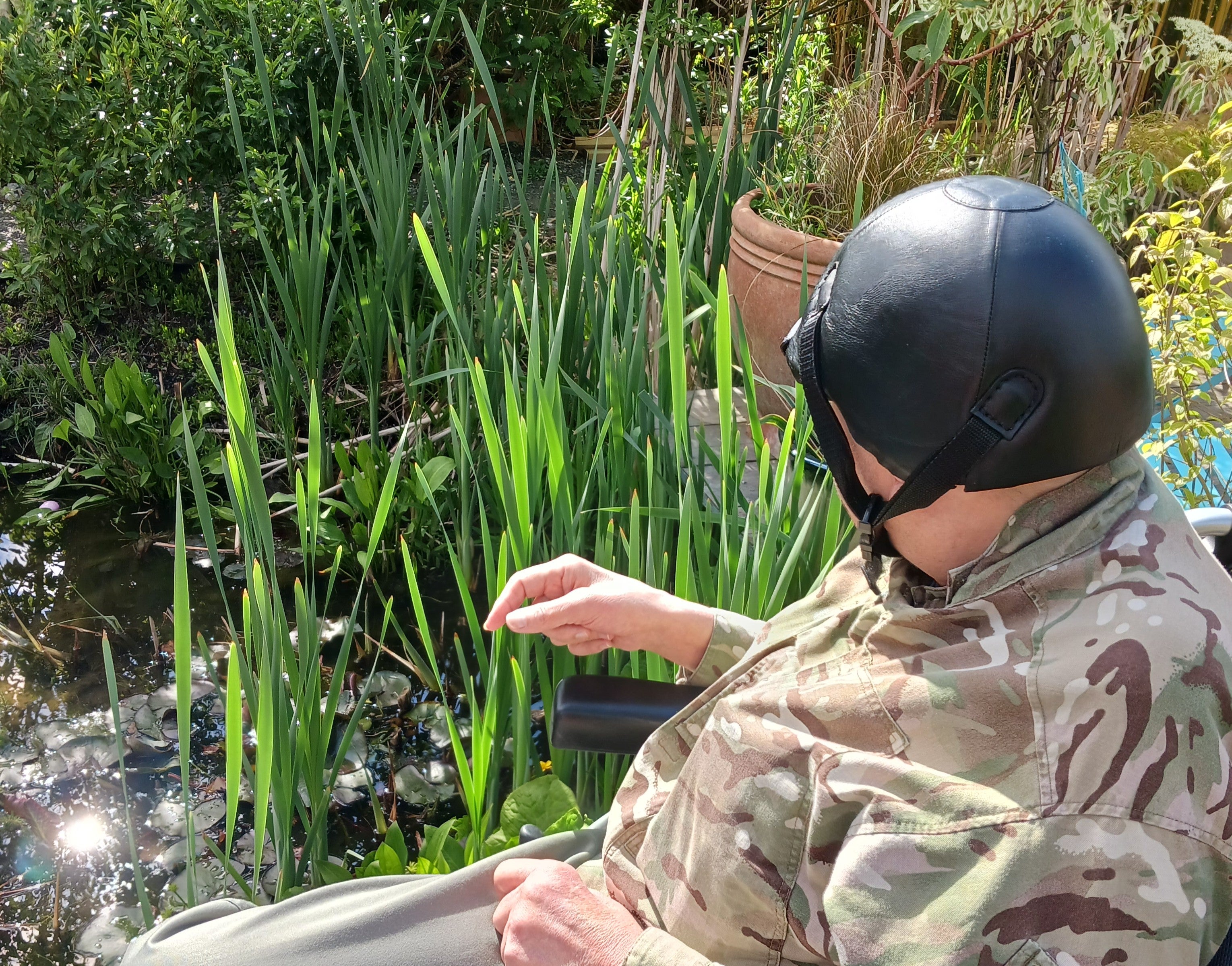A man sitting in a chair near plants