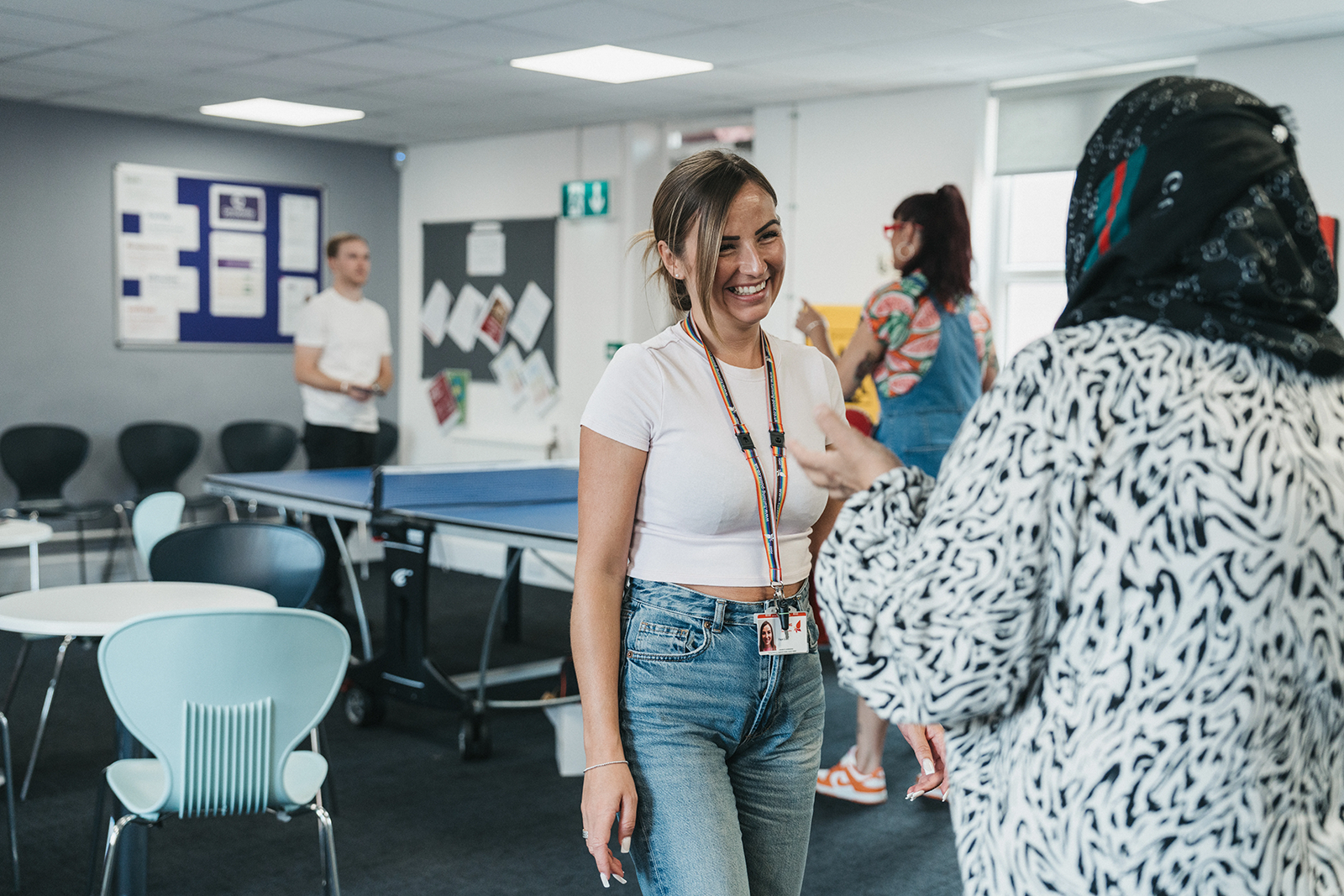 A woman smiling at another woman