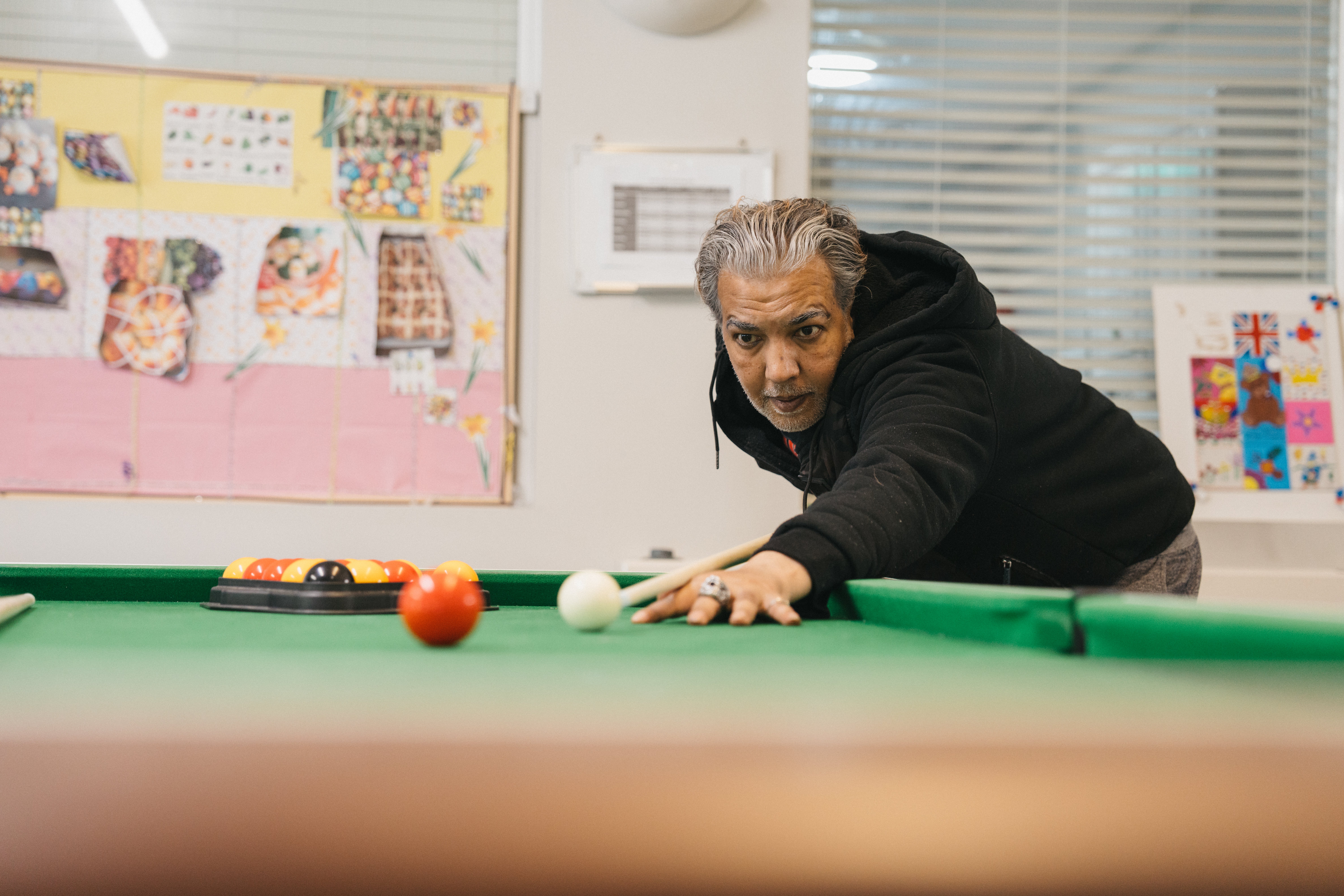 man holding cue playing snooker