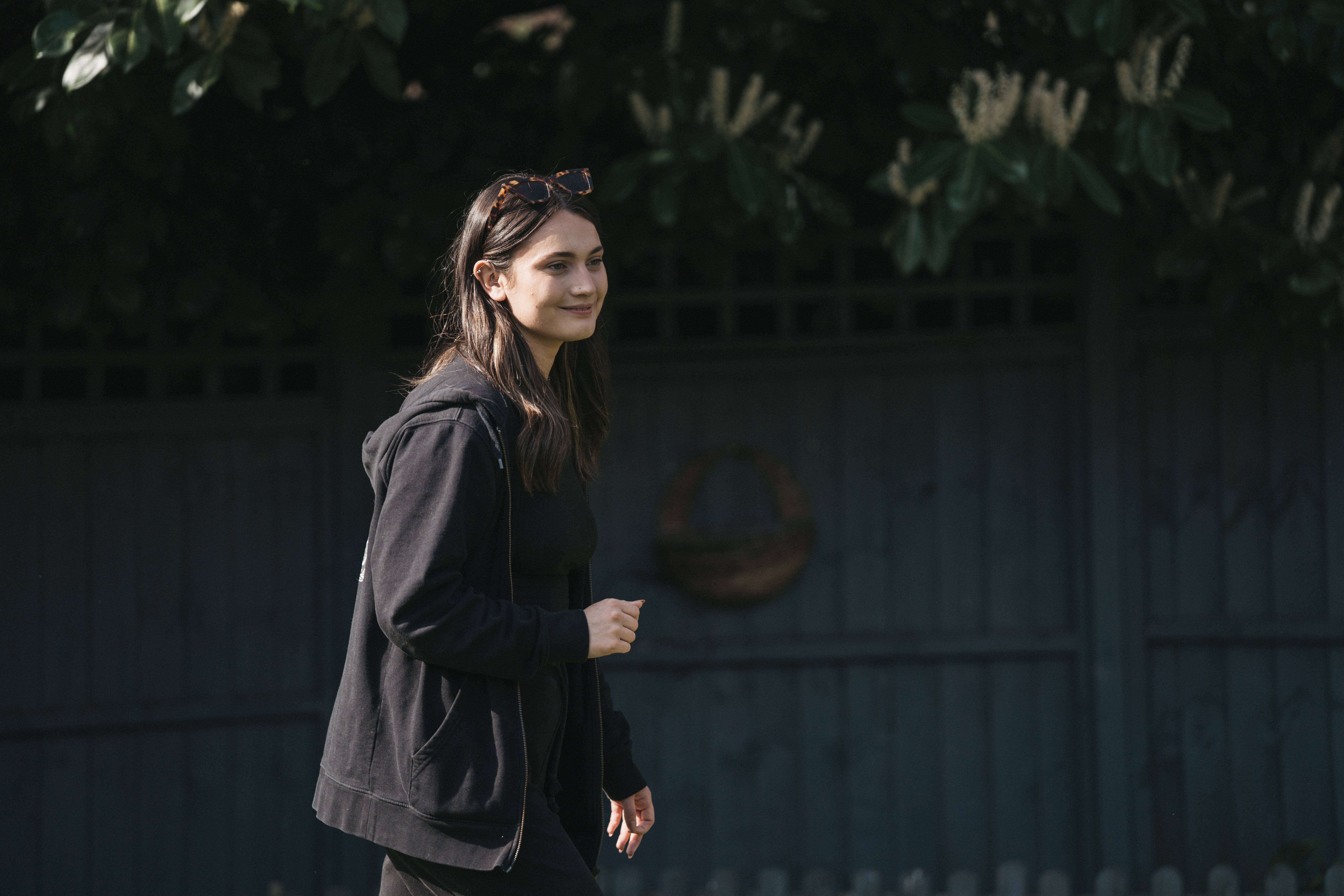 A woman in black jacket walking