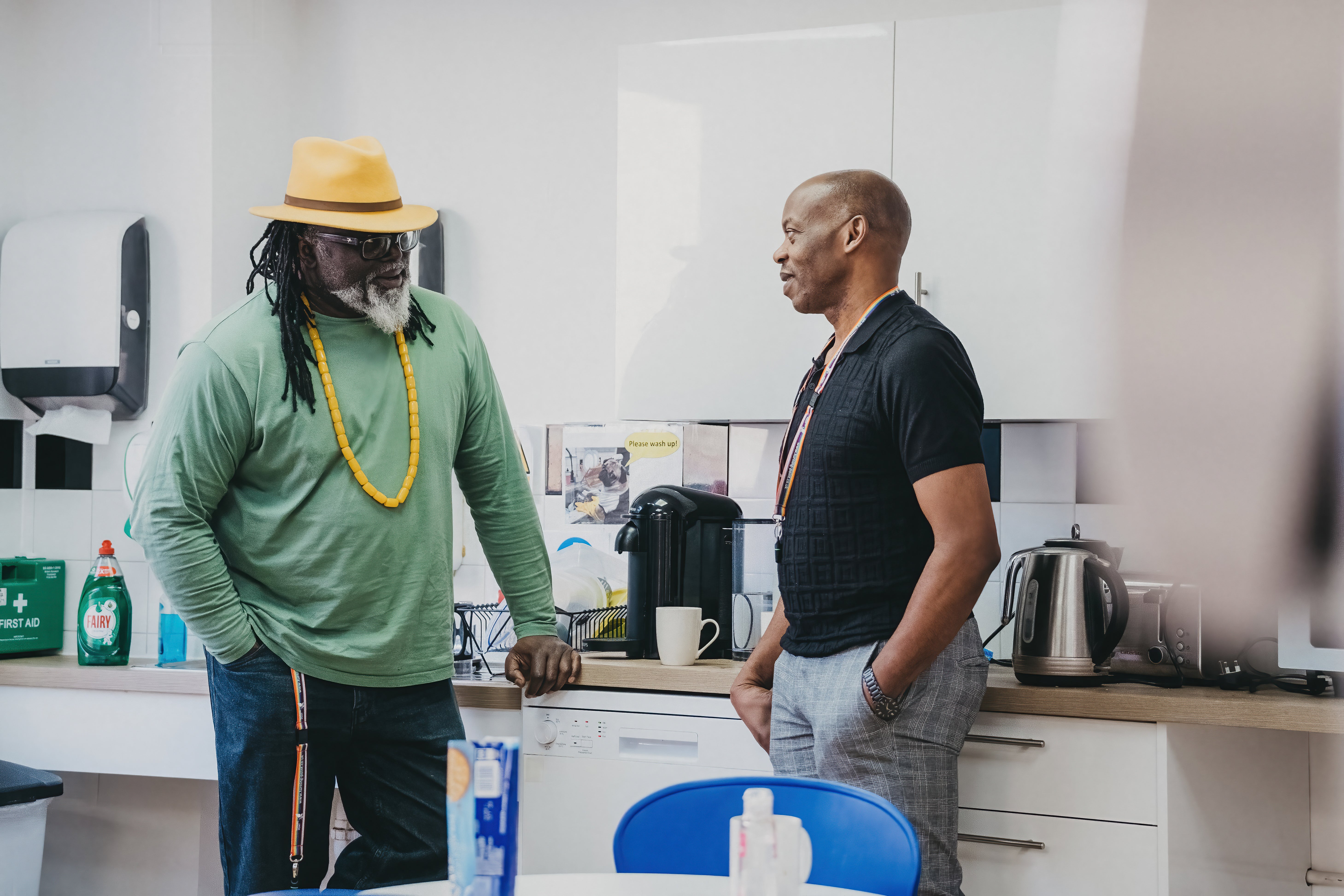 Two men standing in a kitchen