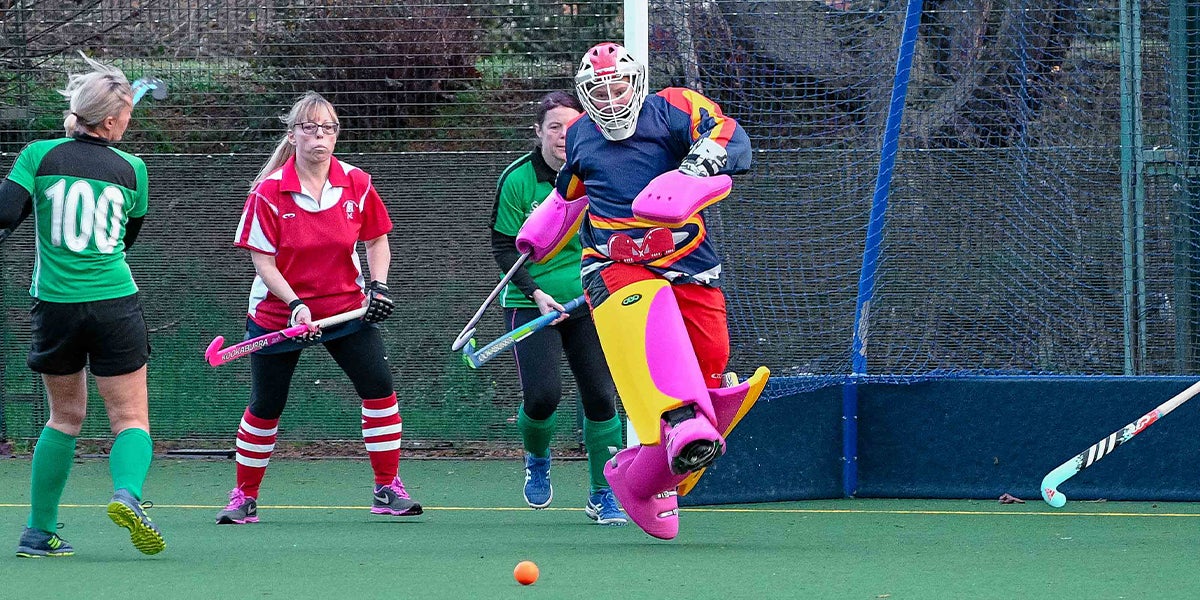Newbury and Thatcham Hockey Club Goalie  kicking the ball making a save 
