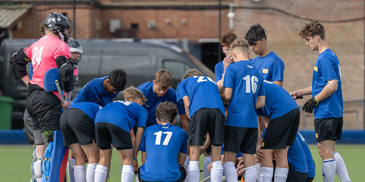 Talent Academy players, boys, Huddling, wearing blue