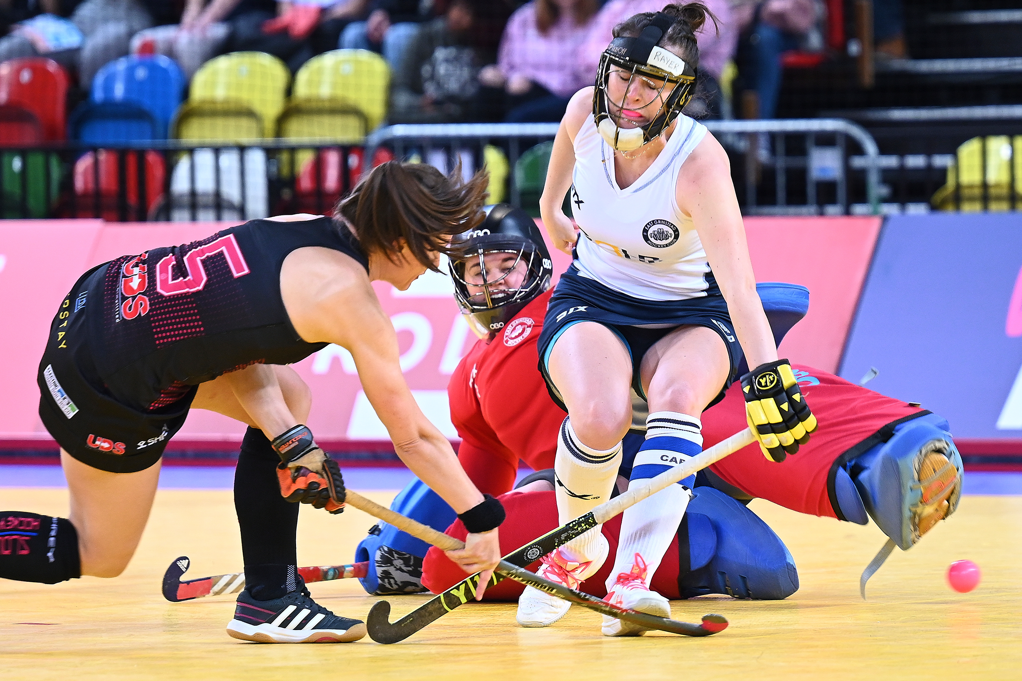 Shot being taken in Womens Indoor Hockey, Defender and goalie try to stop