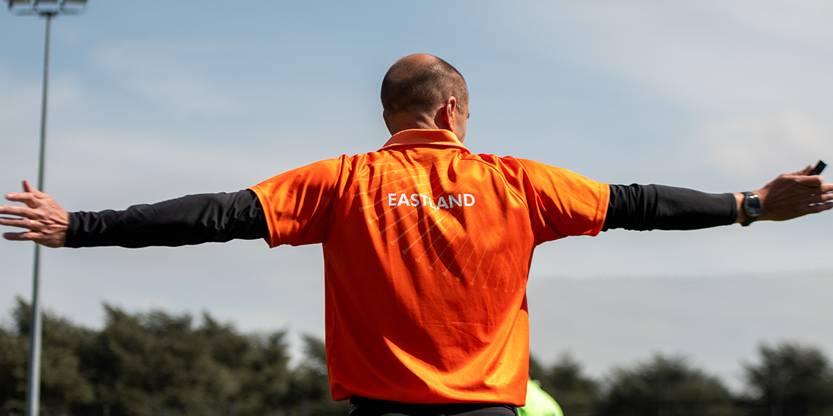 Umpire Eastland holding hands to side