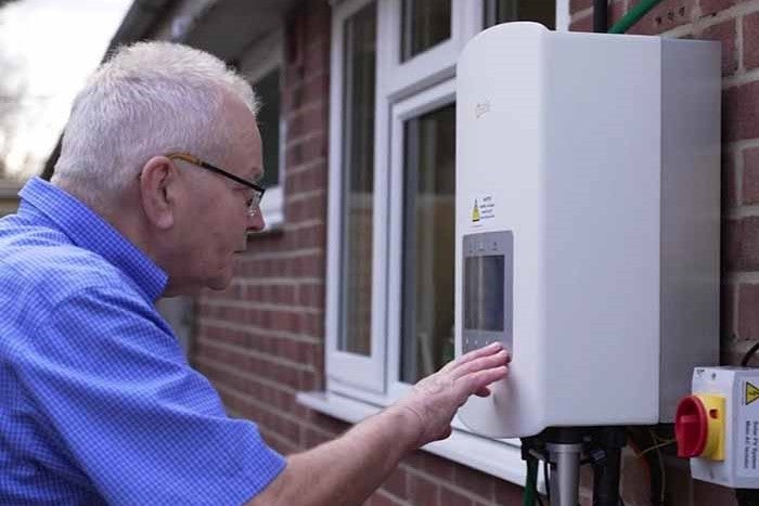 Customer Stephen looks at his heat pump unit.