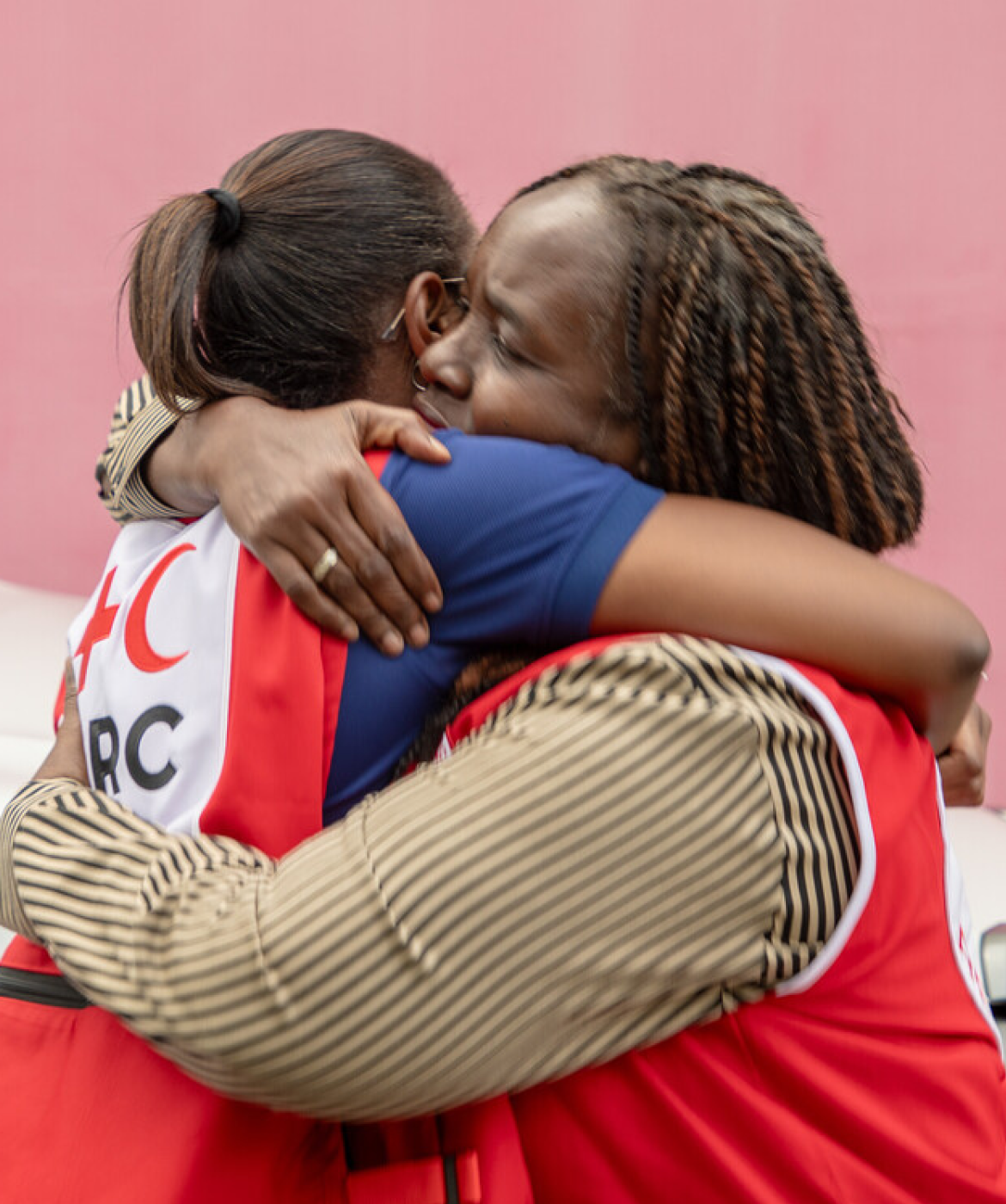 Jamaica Red Cross staff member hugging another person during hurricane response work.