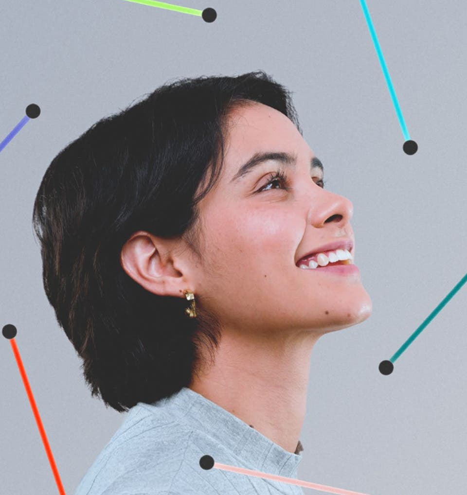 A person is smiling. The background is gray with colourful graphic lines and black dots.