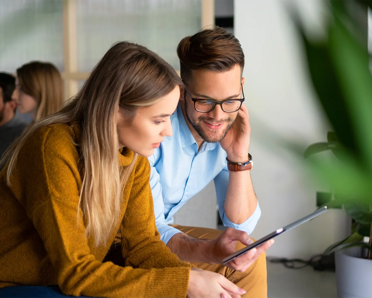 twee mensen die samen naar een tablet kijken