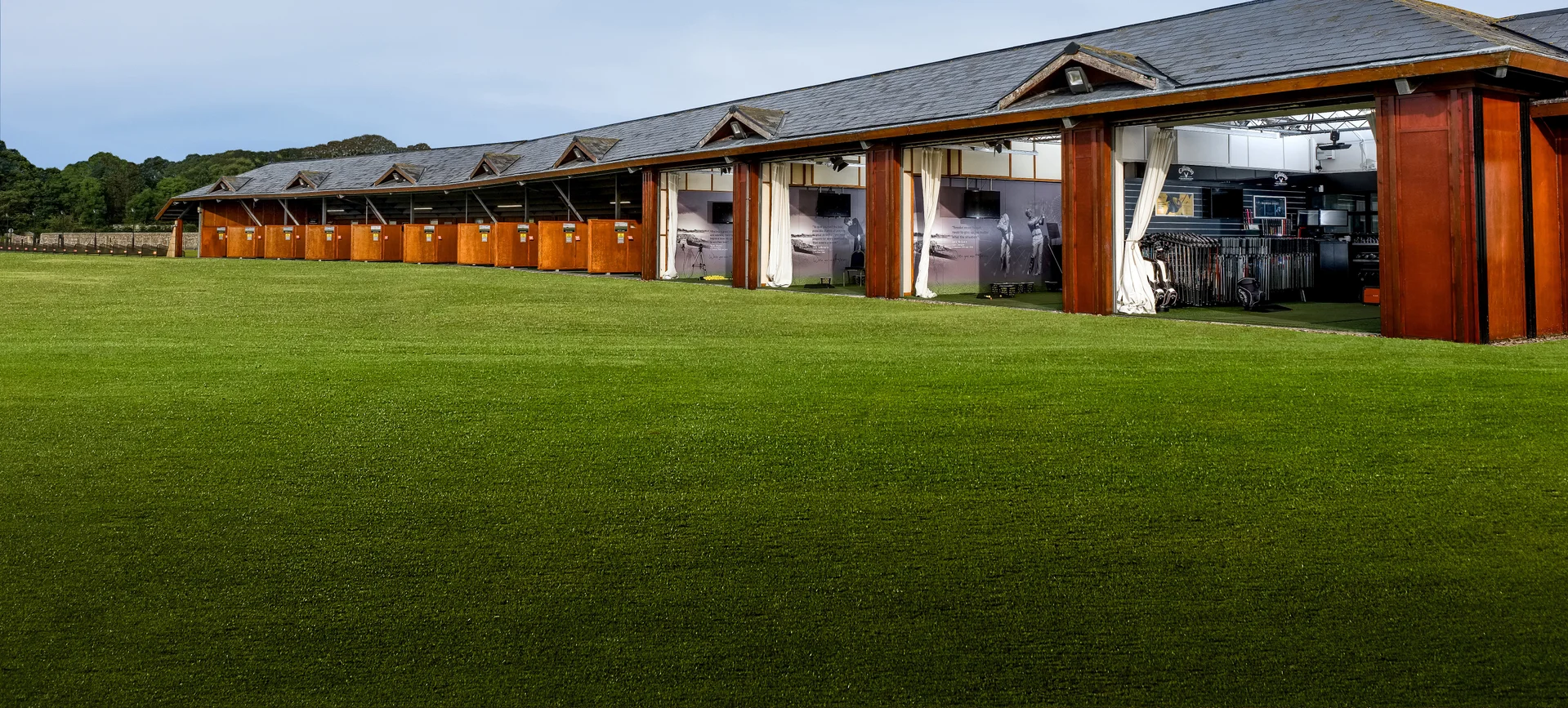 A side view of the bays at the St Andrews Links Golf Academy.