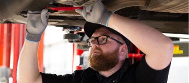 man fixing car