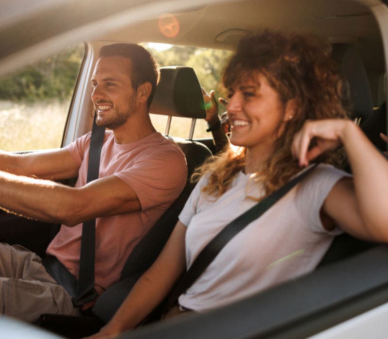Man driving a car with woman in the passenger seat