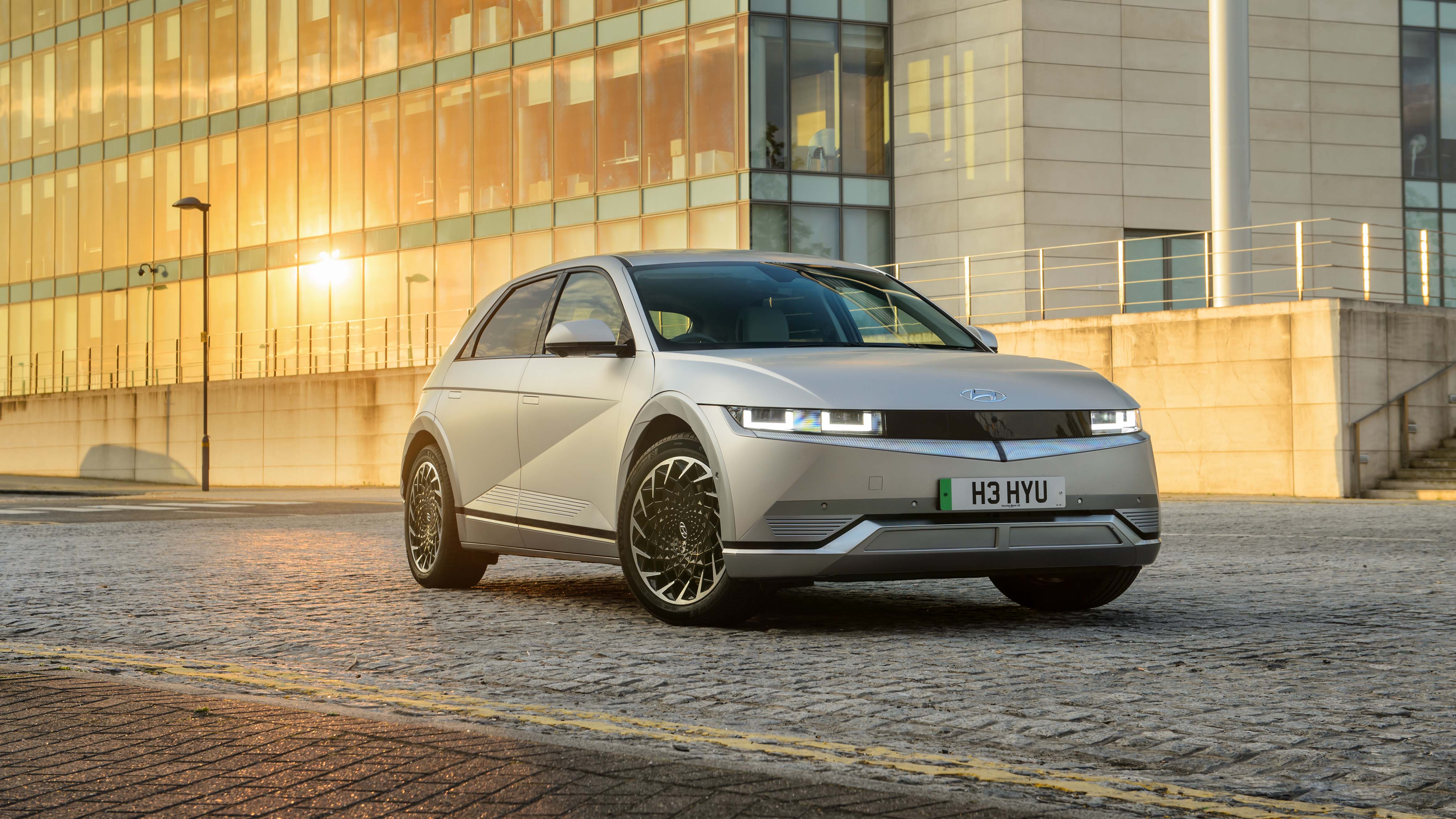Hyundai Ioniq 5 parked in front of sunny building