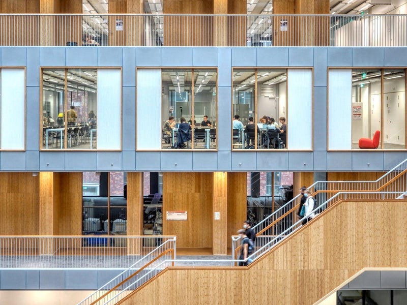 Side view of a staircase leading up along the windows of classrooms in the NU building