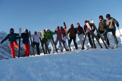 A group of people pose for a photo in the snow