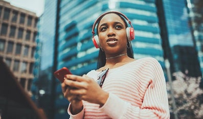  Woman with a cellphone and headphones