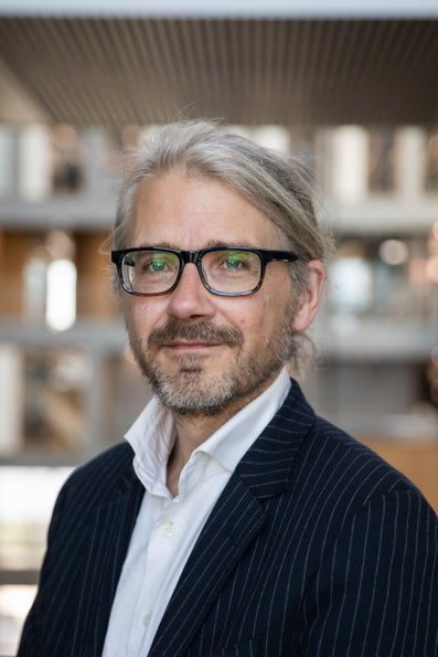 A man with glasses and suit
