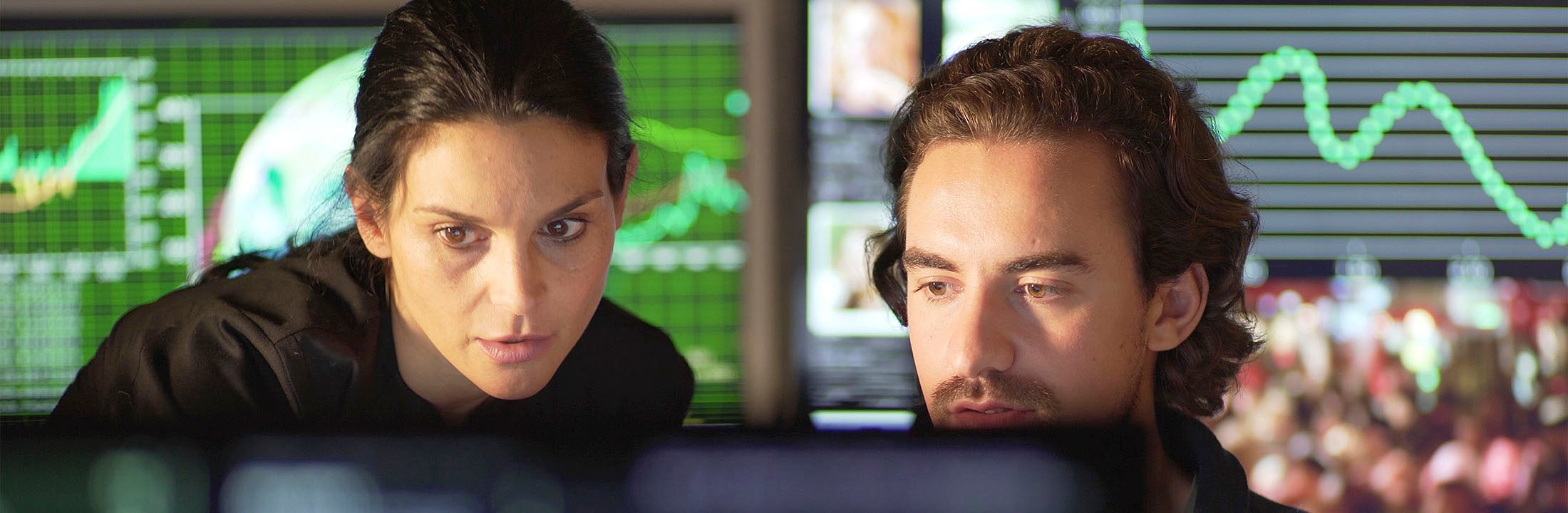 Two people looking at a computer