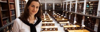 Student met een bibliotheek op de achtergrond
