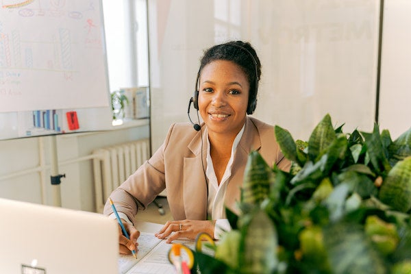 Financial consultant in her office writing on paper
