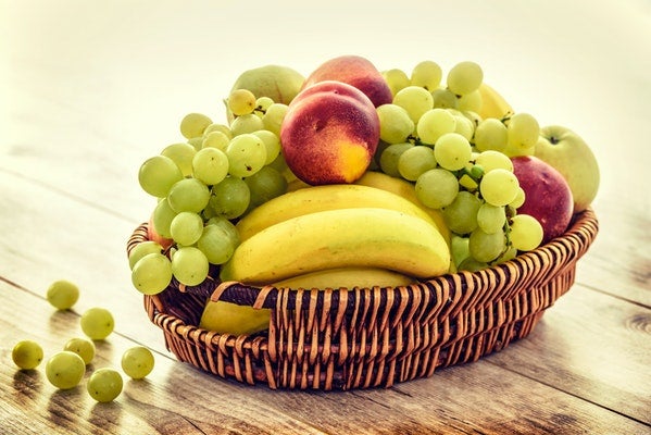 Fruit basket with grapes, peaches and banana