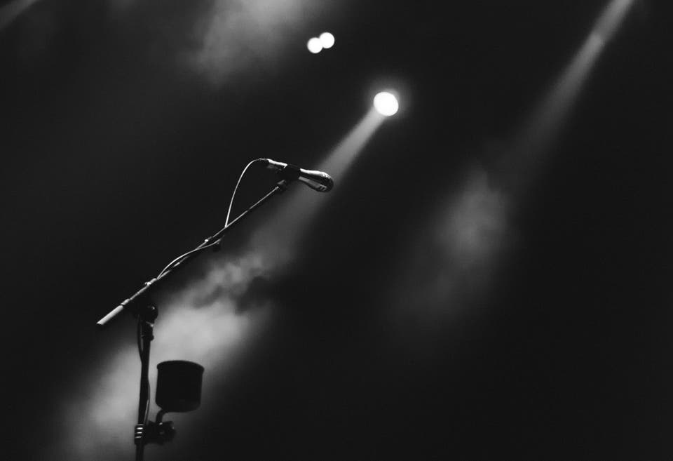 Image of a microphone with atmospheric lighting shining down