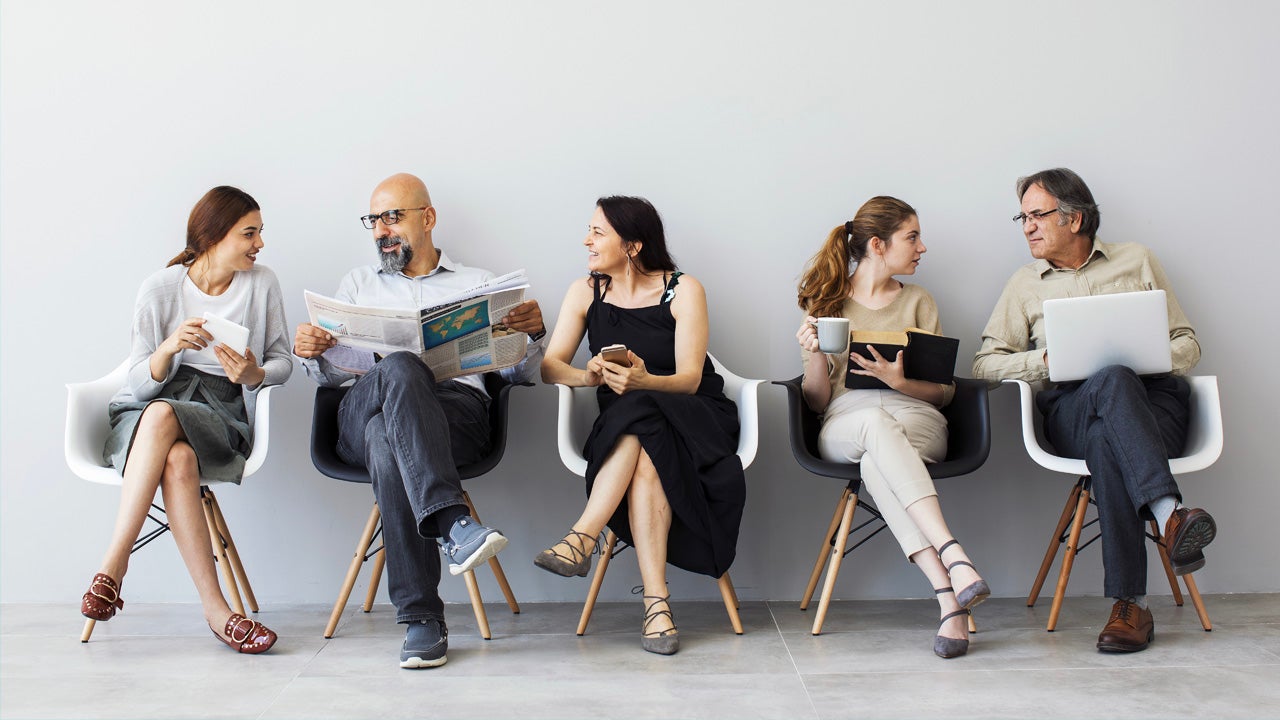 5 people sitting on chairs