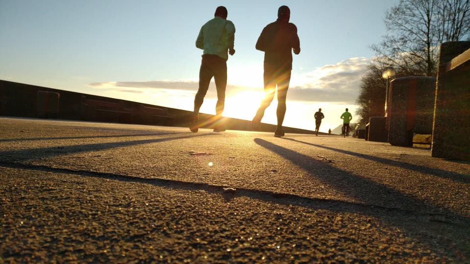 Two people walking into the sunset