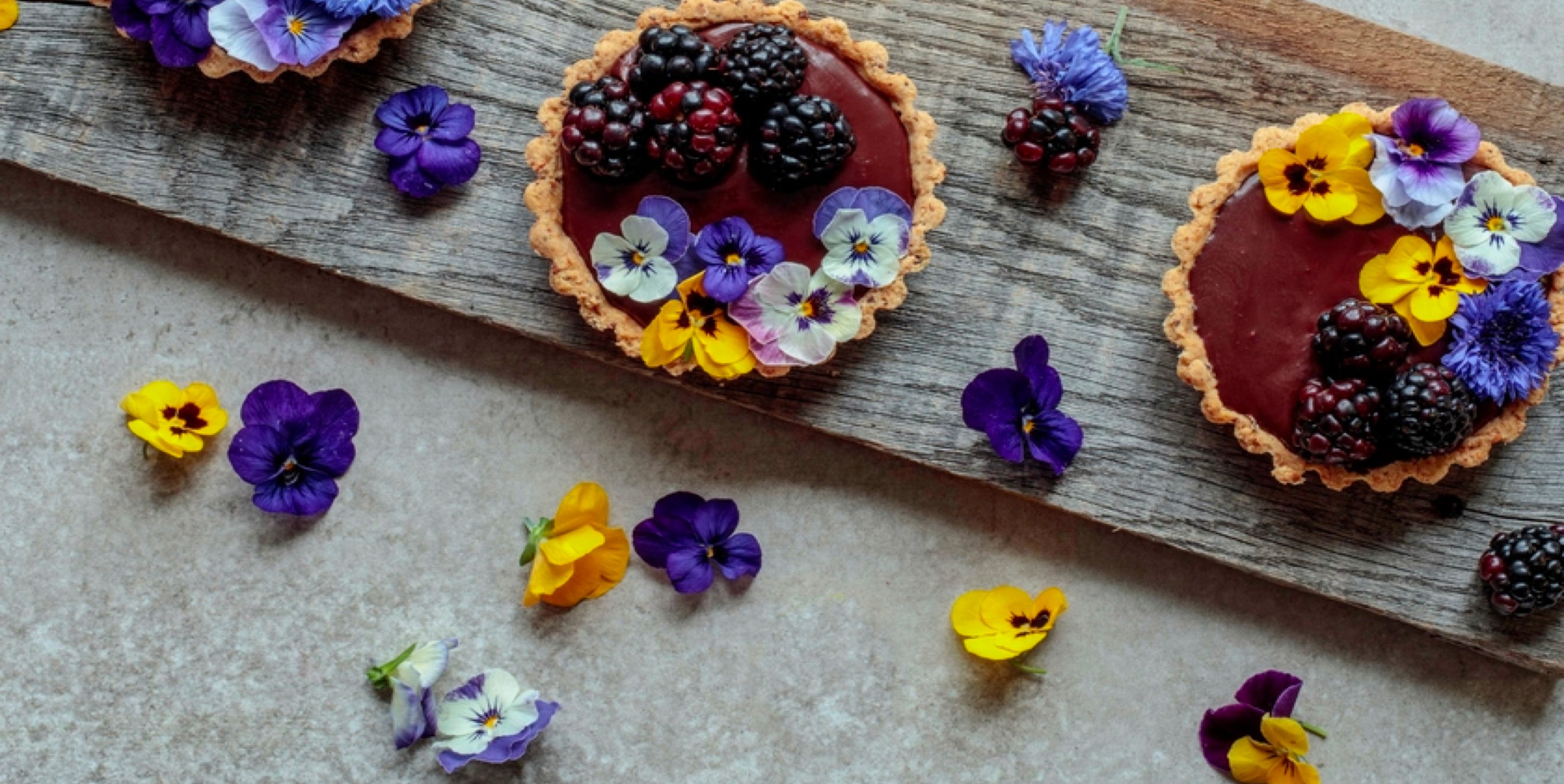 Blackberry tarts with floral decoration