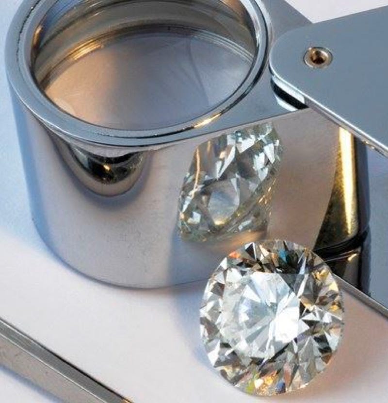 Diamond and magnifying glass
