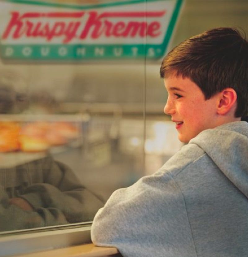 Boy in a Krispy Kreme shop