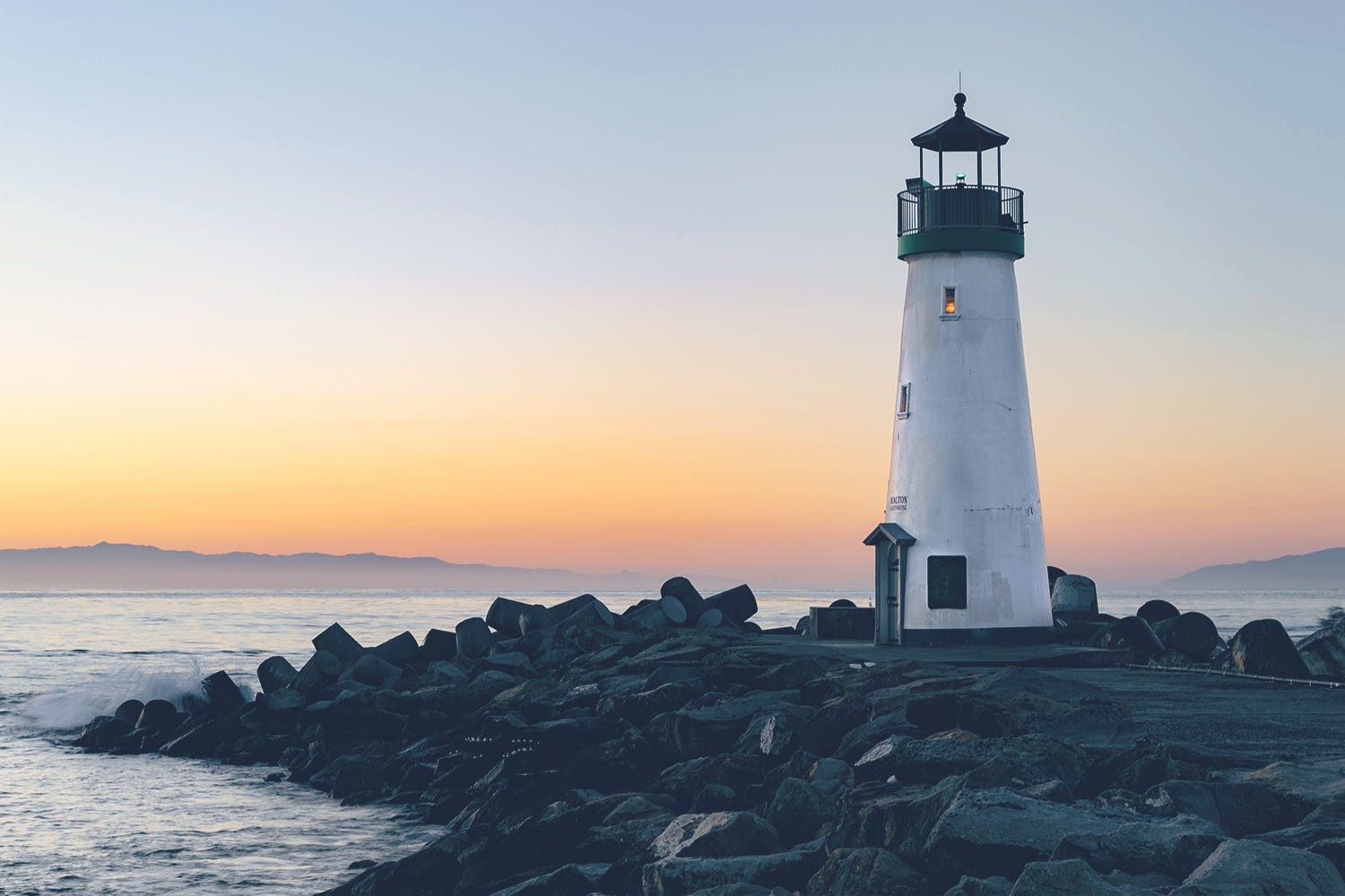 Lighthouse on shoreline at dusk