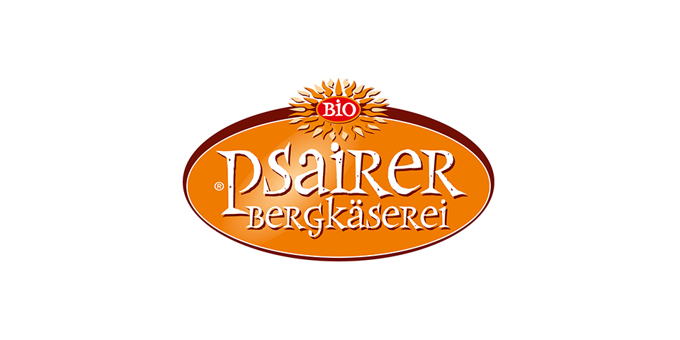Logo del Caseificio di Montagna Passiria, con la scritta "Psaierer Bergkäserei" in un ovale arancione e un sole rosso sopra.