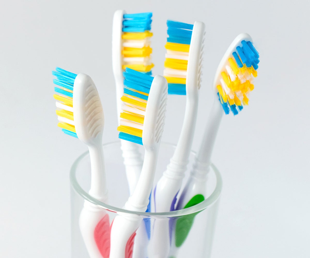 Colourful toothbrushes in a glass
