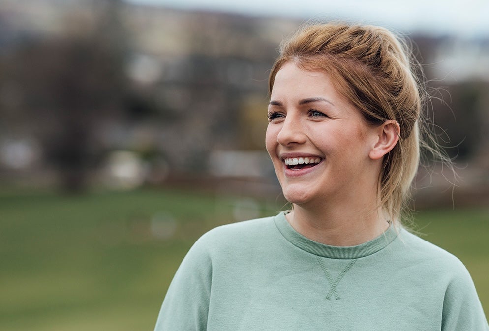 A woman smiling in a green shirt