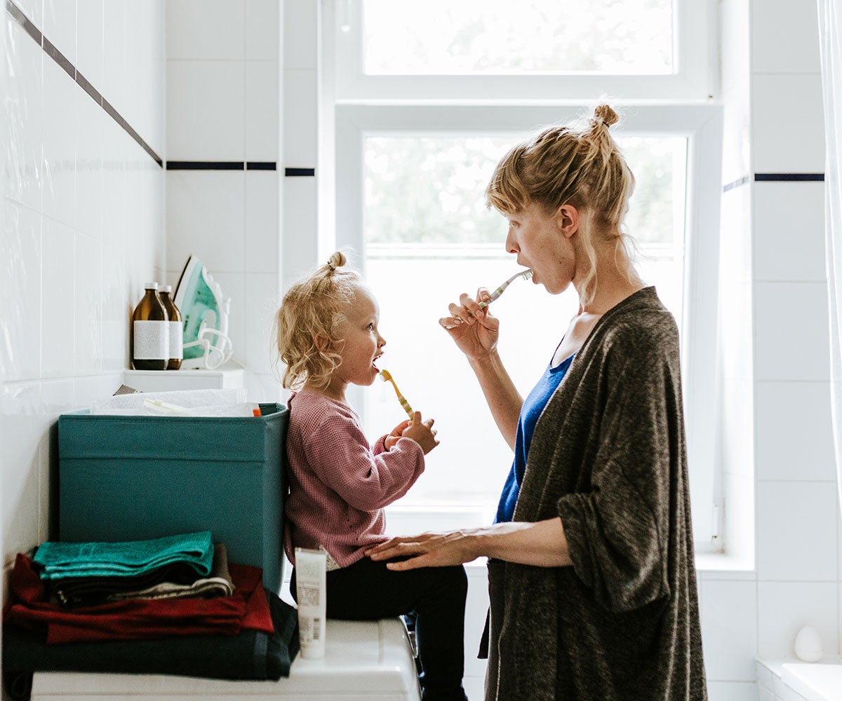 Mum with daughter brushing teeth