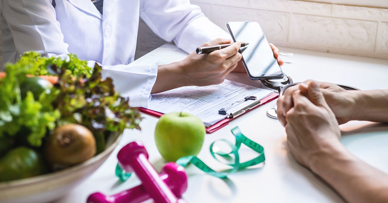 A doctor holding a pen and a phone