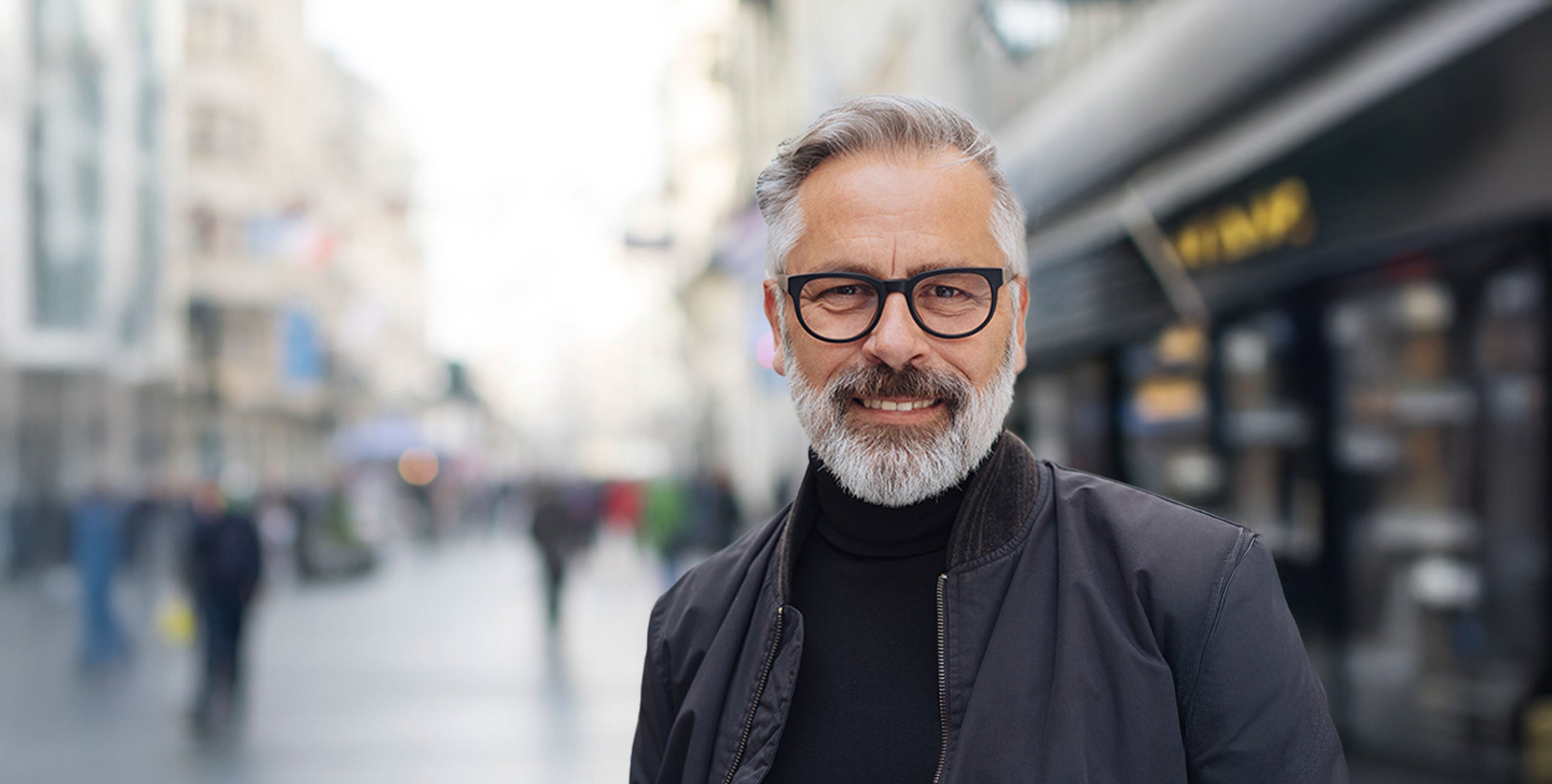A man with a beard and glasses