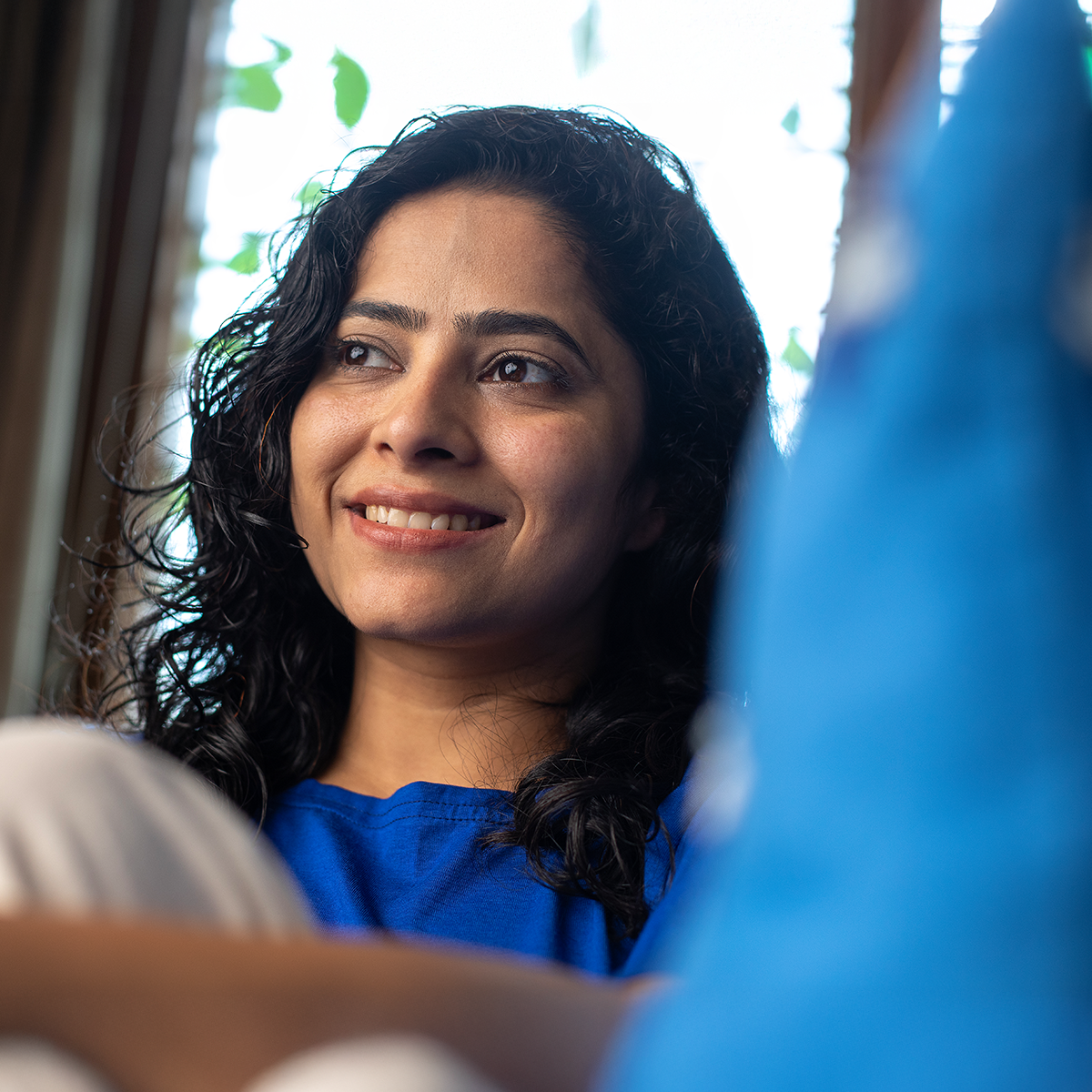 A woman smiling in a blue shirt