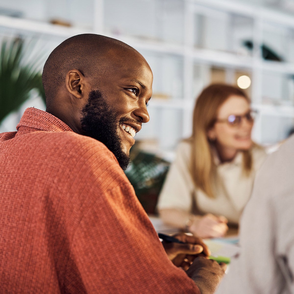 Man in the office in an orange shirt