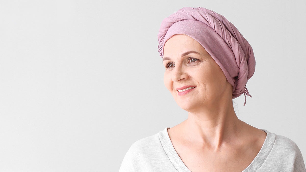 A woman wearing a pink head wrap