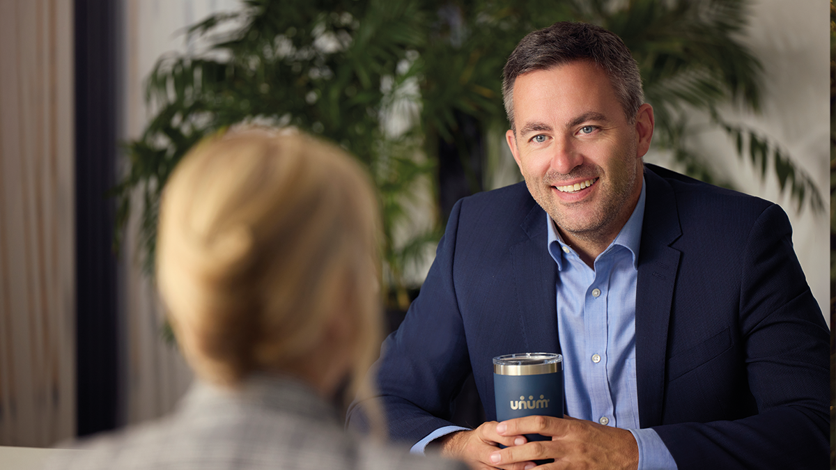 Man smiling during meeting