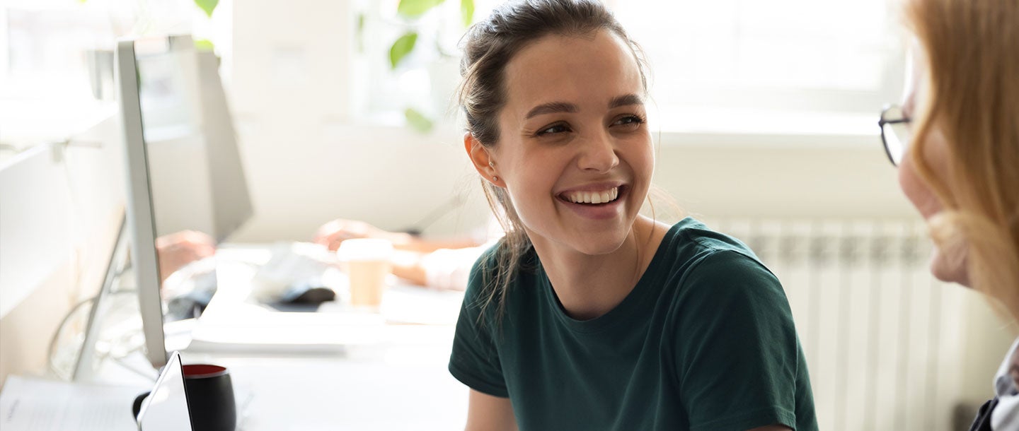 Happy employee having a conversation with an employer